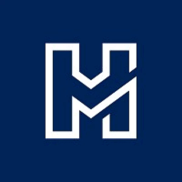 The image shows a stylized white letter "M" on a navy blue background, with angular cuts making the letter appear modern and dynamic.