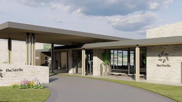 This image shows the entrance of a modern building with the name "theStelle" visible on the exterior walls. The design is contemporary with glass and stone.