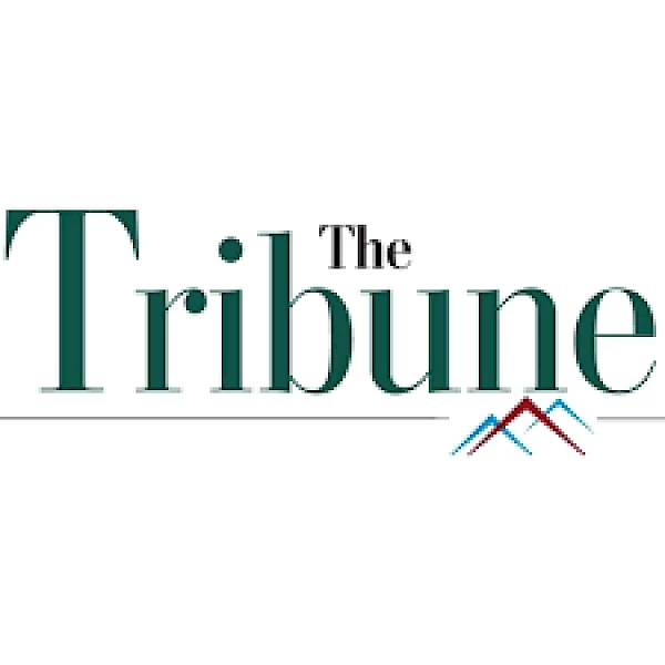 The image shows a logo with the text "The Tribune" in green letters and two colored lines resembling mountains underneath.