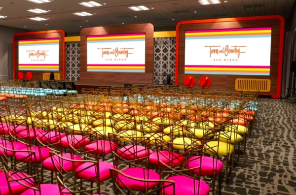 A conference room with colorful chairs and screens displaying "Town and Country San Diego" in a vibrant, well-lit space.