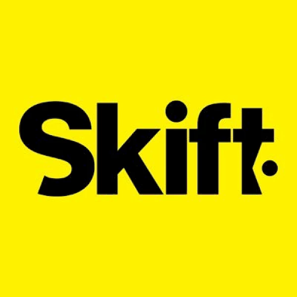 The image displays a yellow background with the black text "Skift" written prominently in the center.